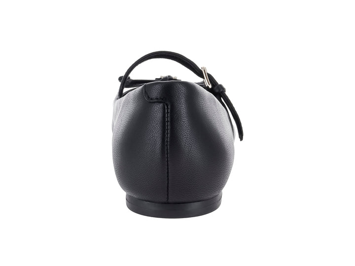 Zapato plano negro de la marca Guess con correa, hebilla y detalle de moño decorativo en la punta.
