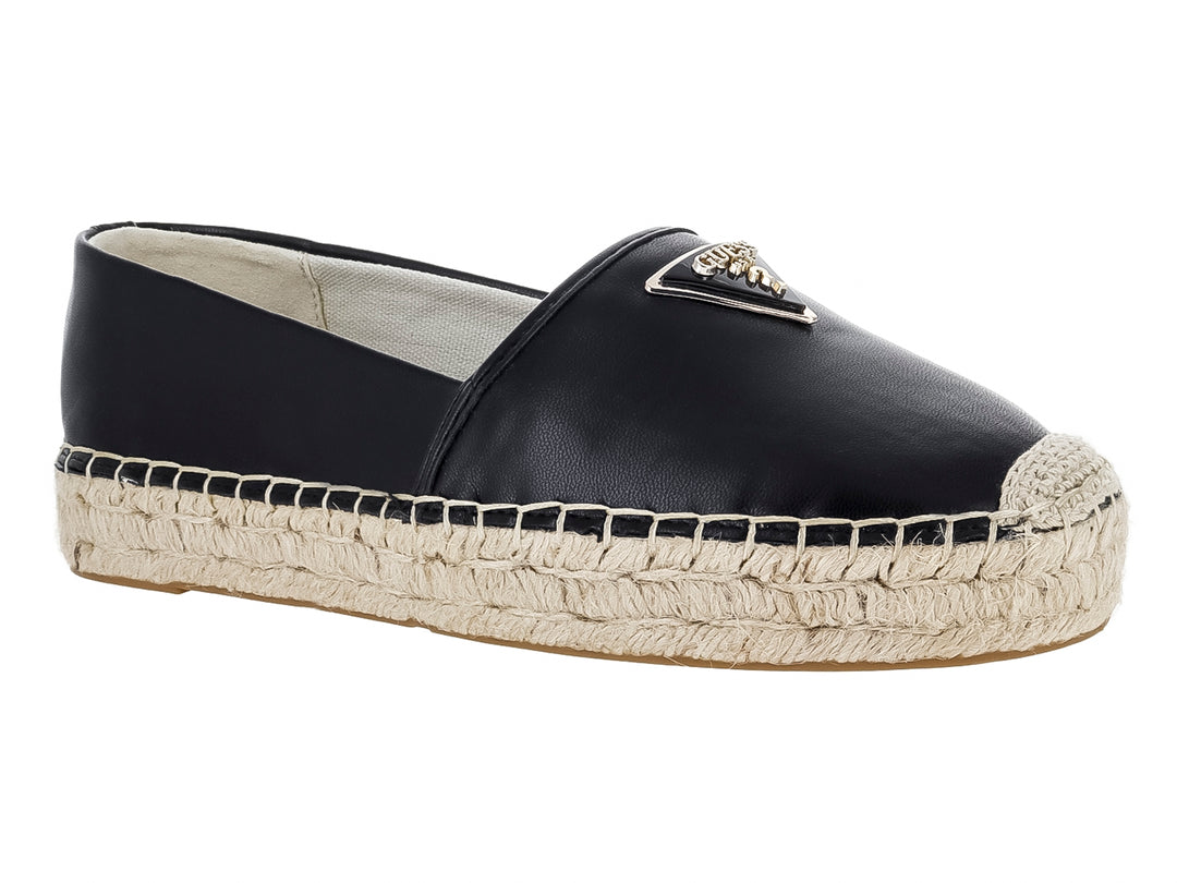 Zapato tipo alpargata color negro con suela de cuerda beige y detalle metálico en la parte superior.