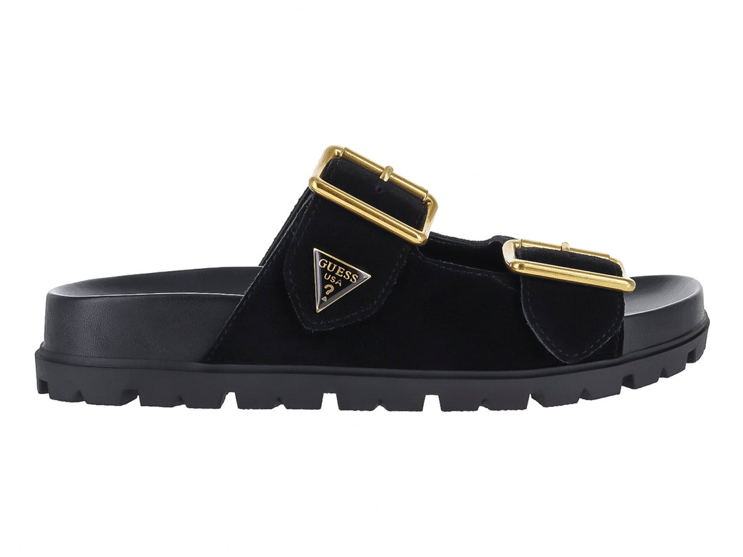 Sandalia negra GUESS con plataforma, suela dentada y dos hebillas decorativas en color dorado.
