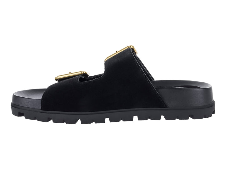 Sandalia negra GUESS con plataforma, suela dentada y dos hebillas decorativas en color dorado.