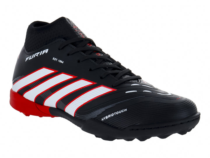 Zapato de fútbol Furia color negro con rayas blancas y suela roja para terreno sintético.