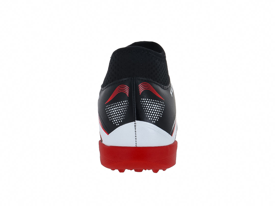Zapato de fútbol Furia color negro con rayas blancas y suela roja para terreno sintético.