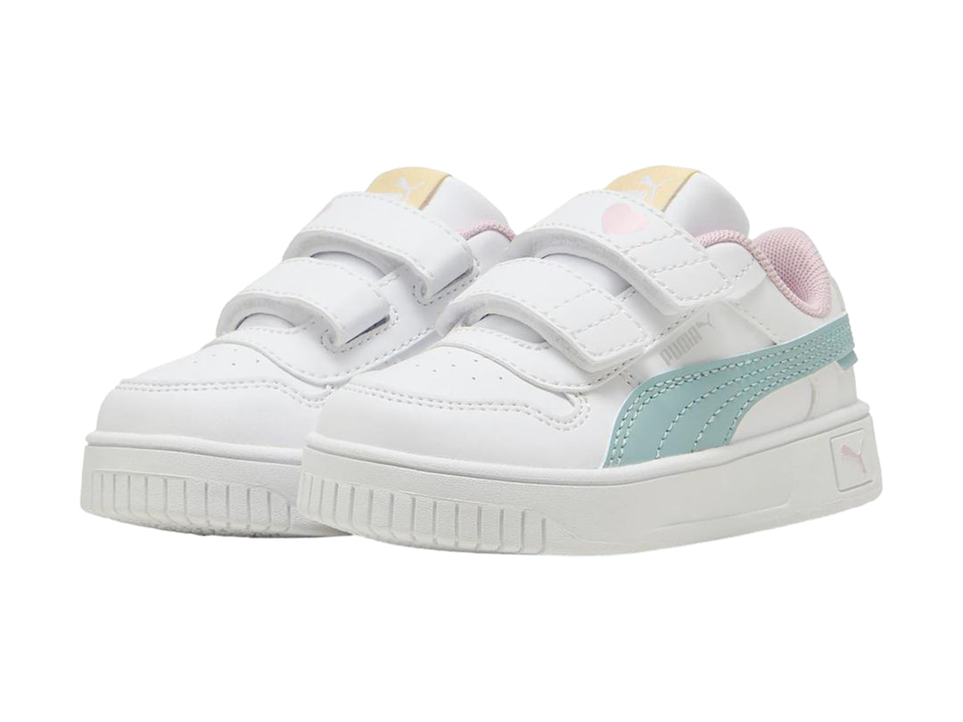 Tenis Puma blancos para niña con franja color menta, detalles en rosa y cierre de velcro.