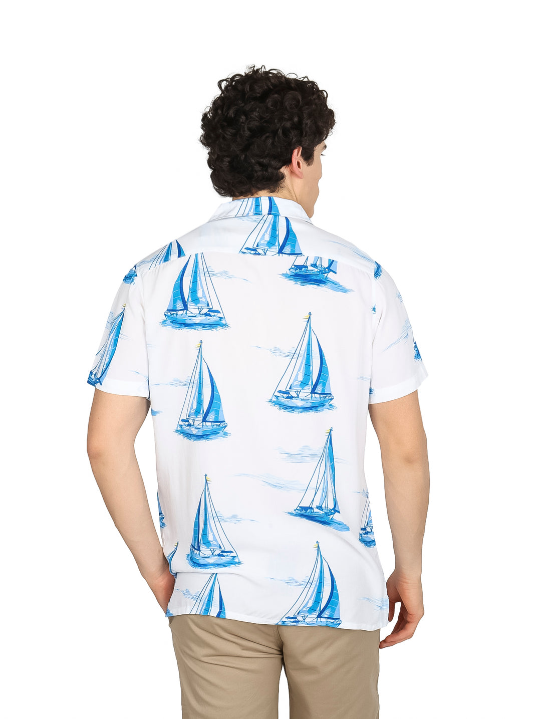 Hombre vistiendo camisa blanca de manga corta con estampado de veleros azules.