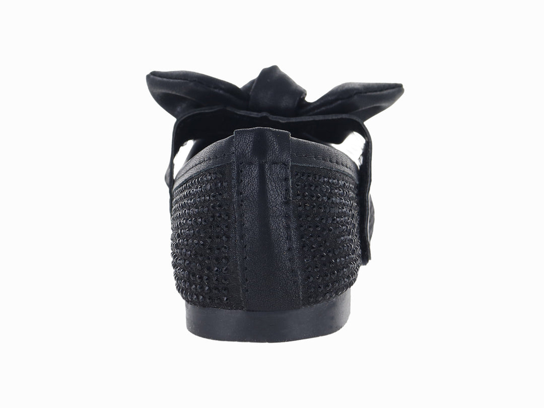 Zapato plano color negro con moño decorativo y acabado texturizado.