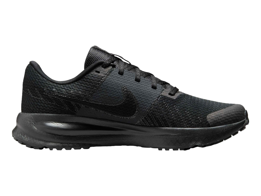 Tenis deportivos Nike Run Defy en color negro con suela gruesa y malla transpirable.