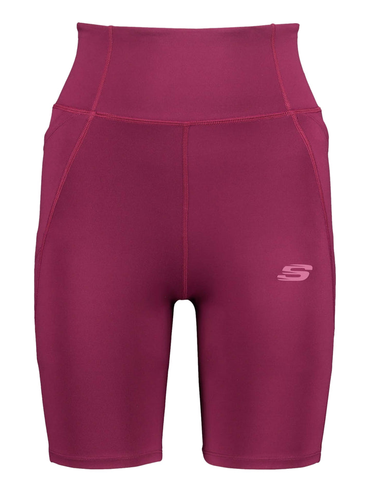 Mujer vistiendo biker shorts deportivos de color fucsia de la marca Skechers.