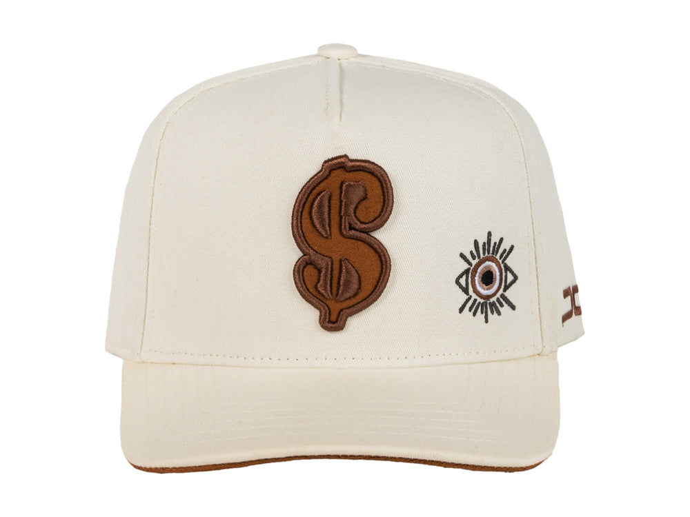 Gorra snapback color beige con bordados en marrón, incluyendo un símbolo de dólar y un ojo.