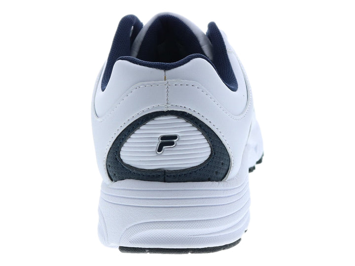 Tenis deportivos FILA de color blanco con detalles en azul marino y suela blanca.