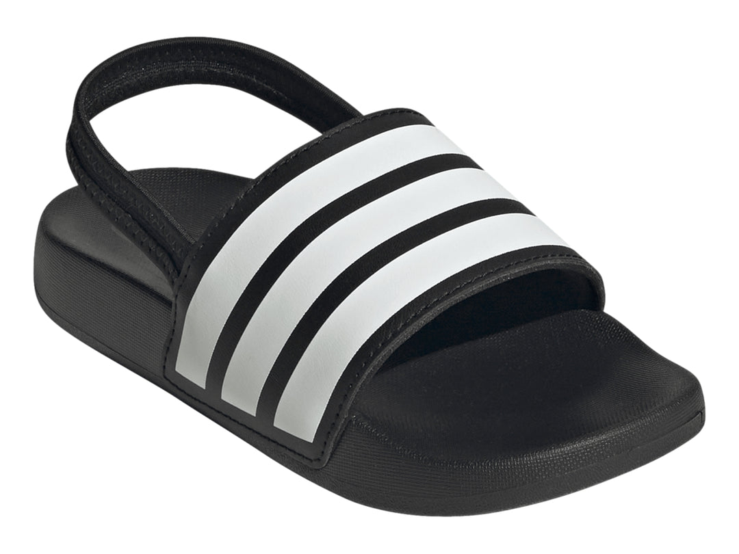 Sandalias Adidas Adilette negras para niños con tres franjas blancas en la correa.