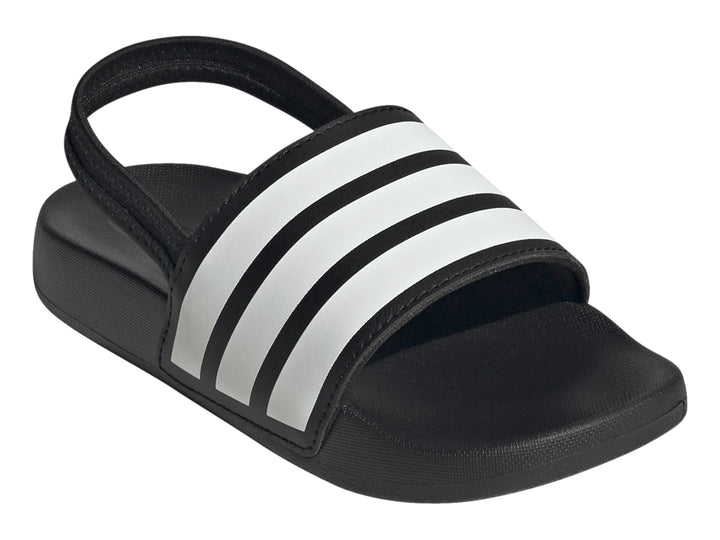 Sandalias Adidas Adilette negras para niños con tres franjas blancas en la correa.
