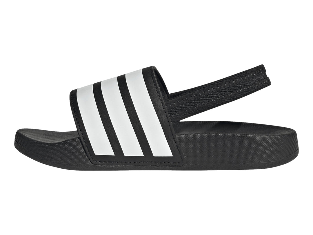 Sandalias Adidas Adilette negras para niños con tres franjas blancas en la correa.