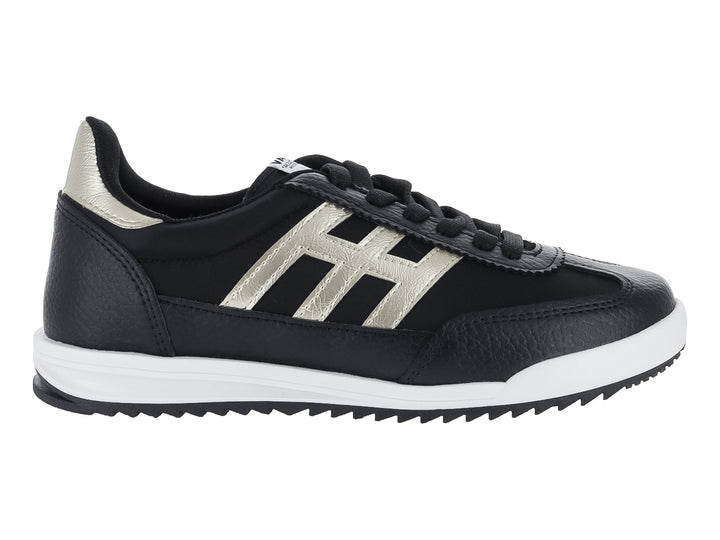 Tenis deportivos color negro con detalles en dorado y suela blanca.