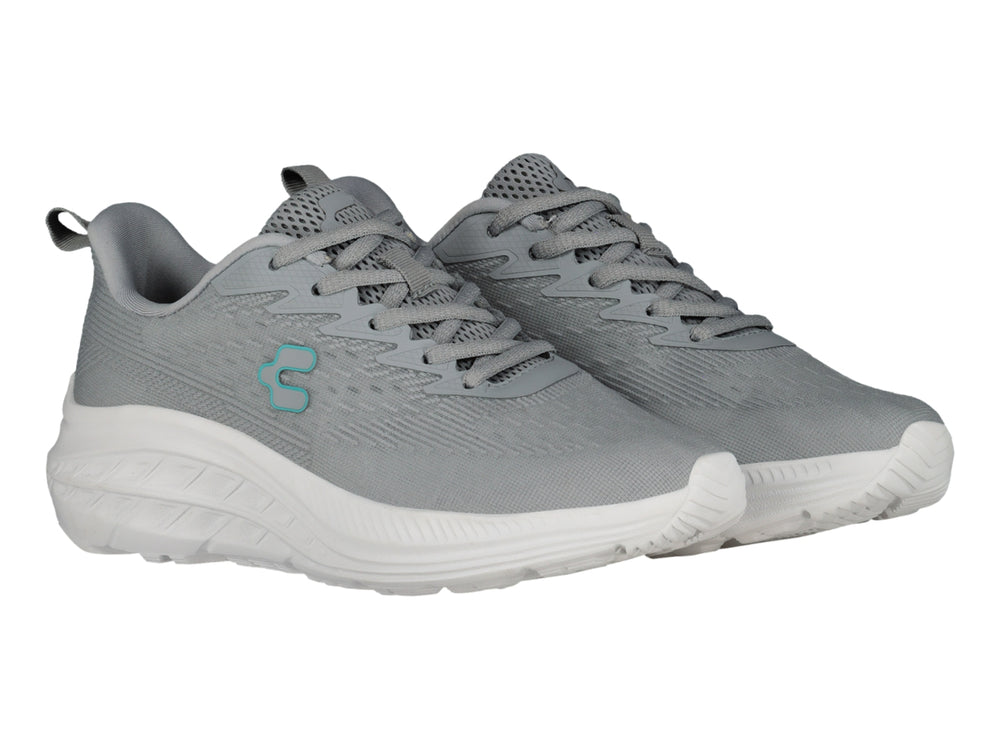 Tenis deportivos Charly color gris con suela blanca y logotipo en azul claro.