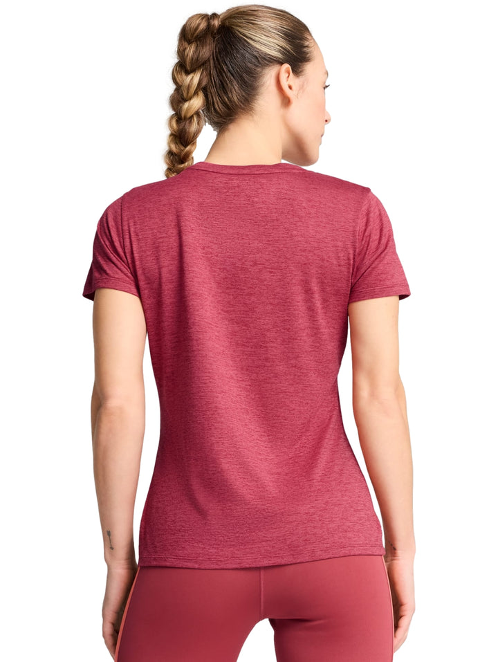 Mujer vistiendo playera deportiva PUMA color guinda jaspeado con logo en el pecho.