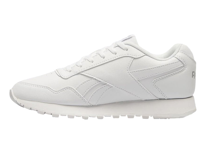 Tenis deportivos Reebok de color blanco para niños con suela blanca y cordones.