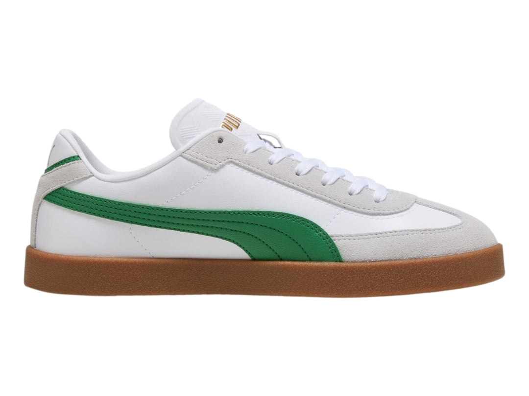Tenis PUMA blancos con franja verde y suela de goma color café.