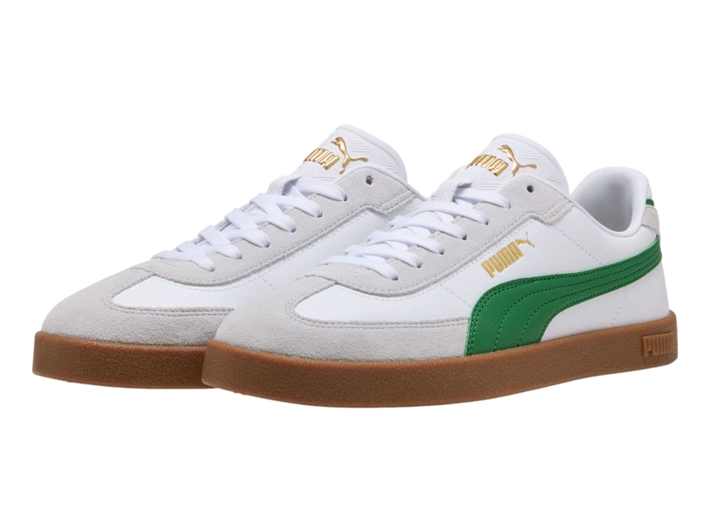 Tenis PUMA blancos con franja verde y suela de goma color café.