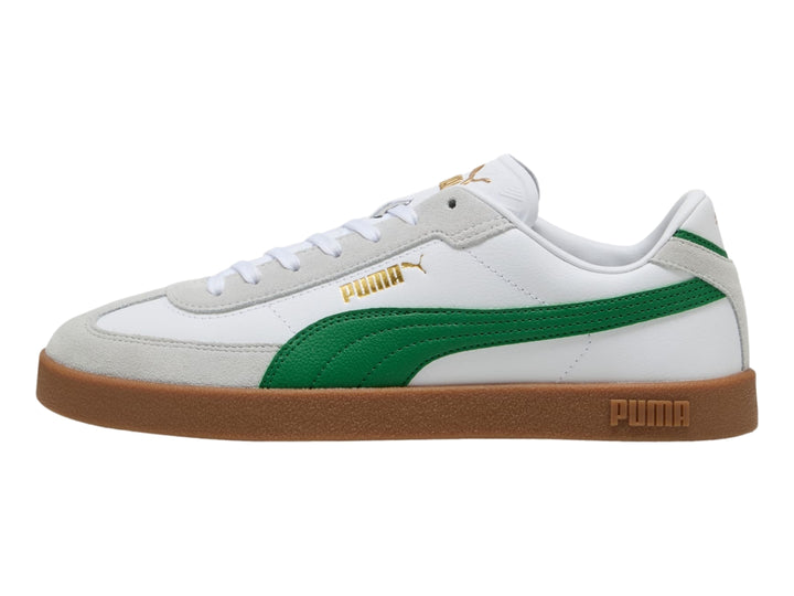 Tenis PUMA blancos con franja verde y suela de goma color café.