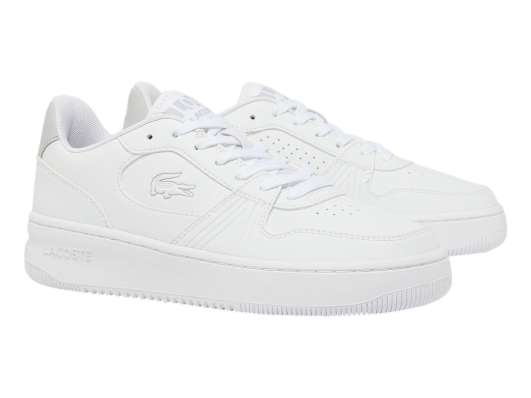Tenis Lacoste blancos de corte bajo con detalle gris en el talón y suela blanca.