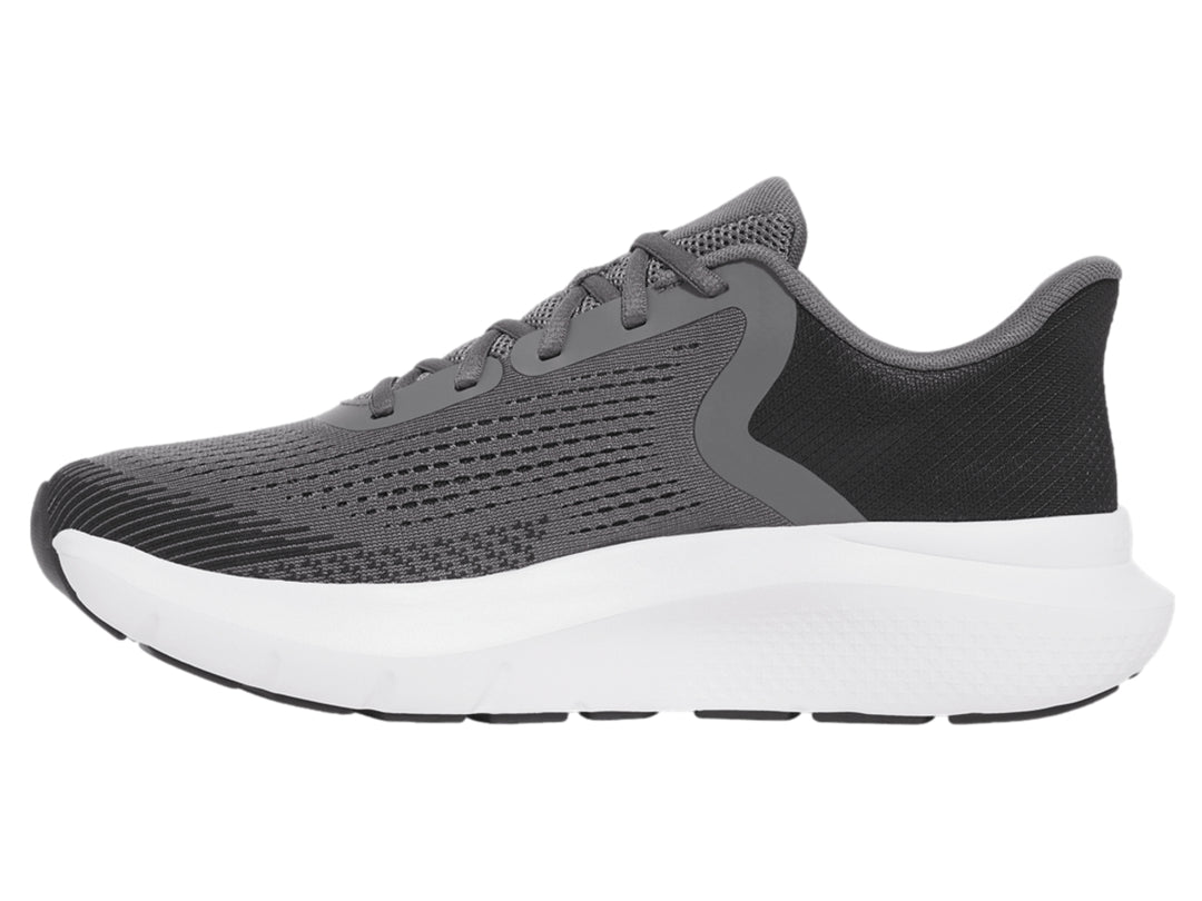Tenis deportivos Under Armour color gris con suela blanca y logo dorado.