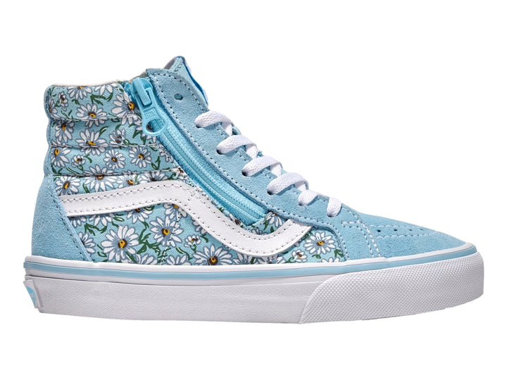 Tenis Vans azul con estampado de margaritas blancas, cierre lateral y suela blanca.