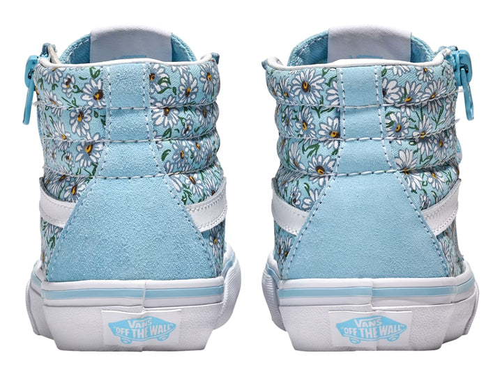 Tenis Vans azul con estampado de margaritas blancas, cierre lateral y suela blanca.