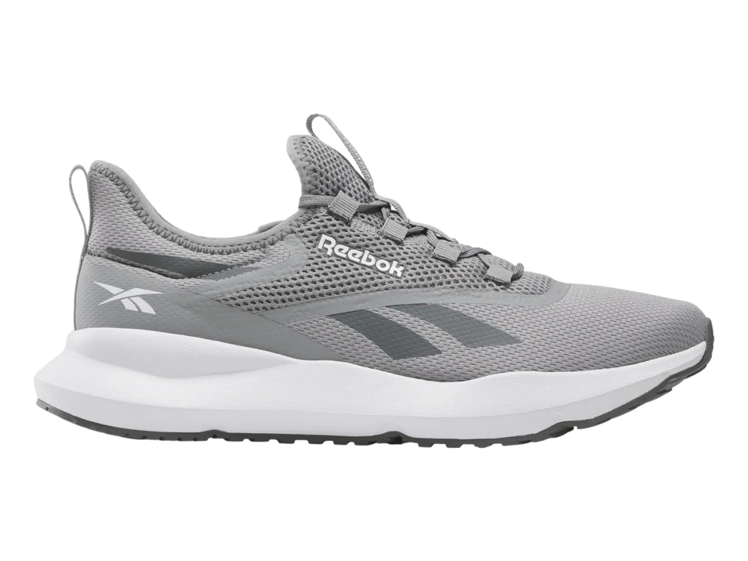 Tenis deportivos Reebok color gris con suela blanca y tejido de malla.