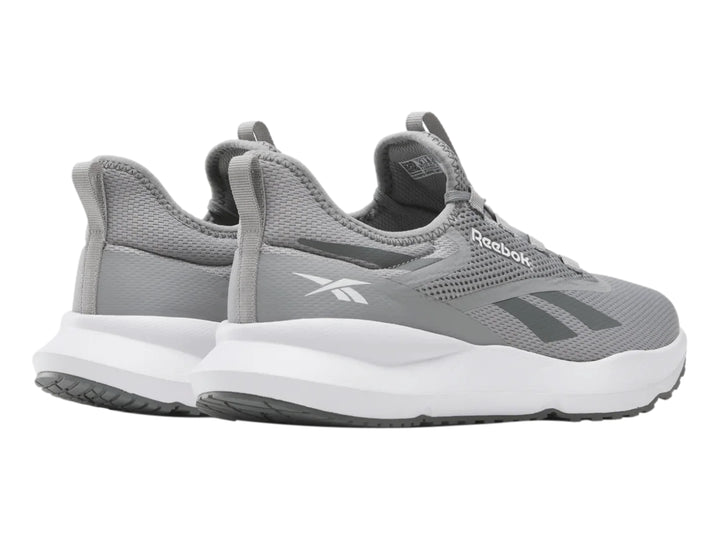 Tenis deportivos Reebok color gris con suela blanca y tejido de malla.