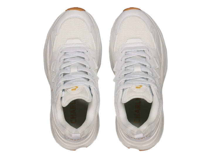 Tenis deportivos Charly blancos con detalles dorados y suela color caramelo.