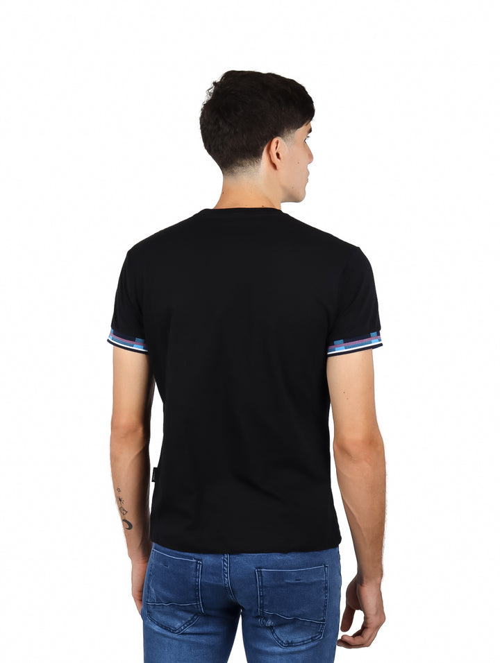 Hombre vistiendo playera negra de manga corta con estampado azul en el pecho y detalles en las mangas.
