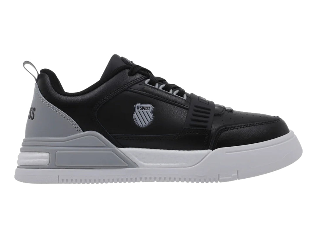 Tenis K-Swiss en colores negro, gris y blanco con suela gruesa y diseño deportivo.