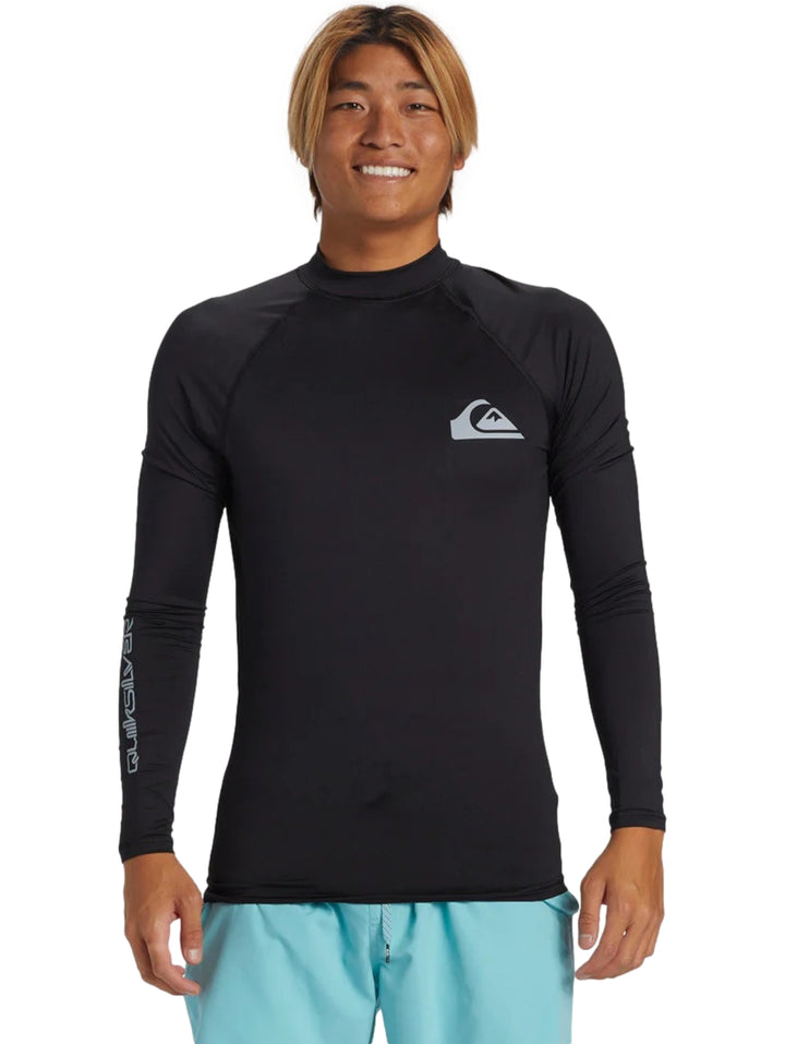 Hombre usando playera deportiva de manga larga color negro marca Quiksilver.