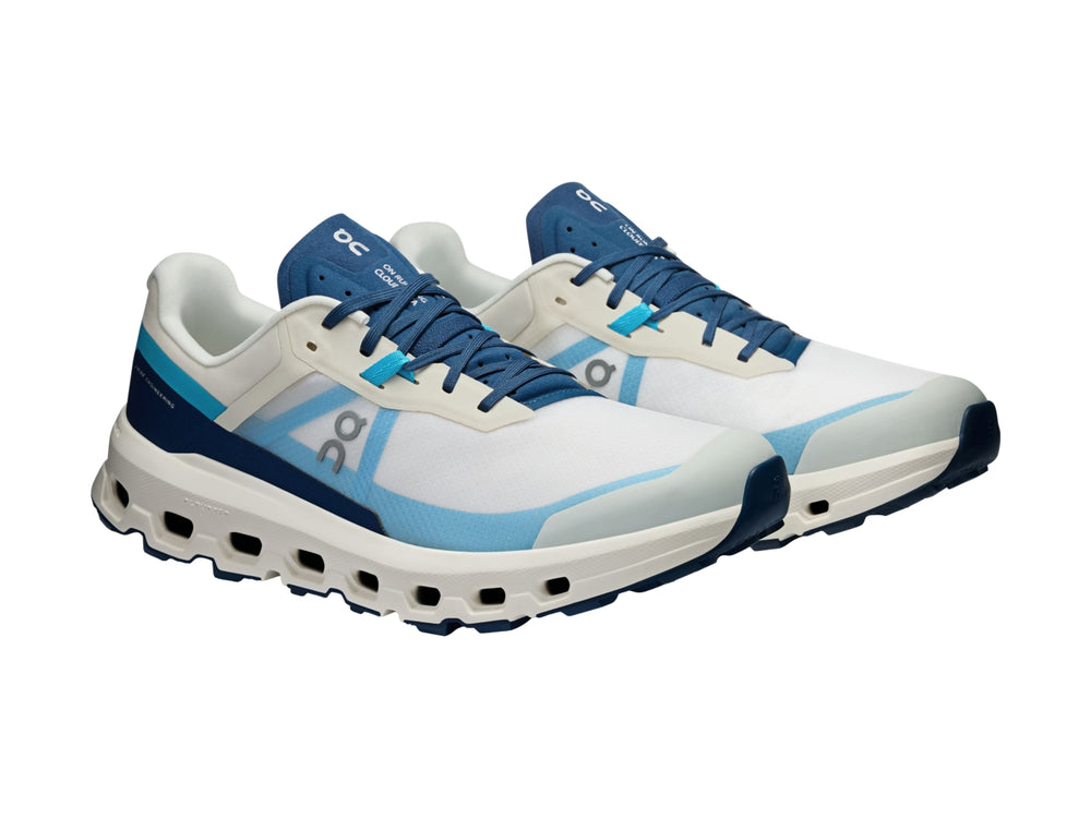 Tenis deportivos On Cloud en colores blanco y azul con suela amortiguada y malla transpirable.