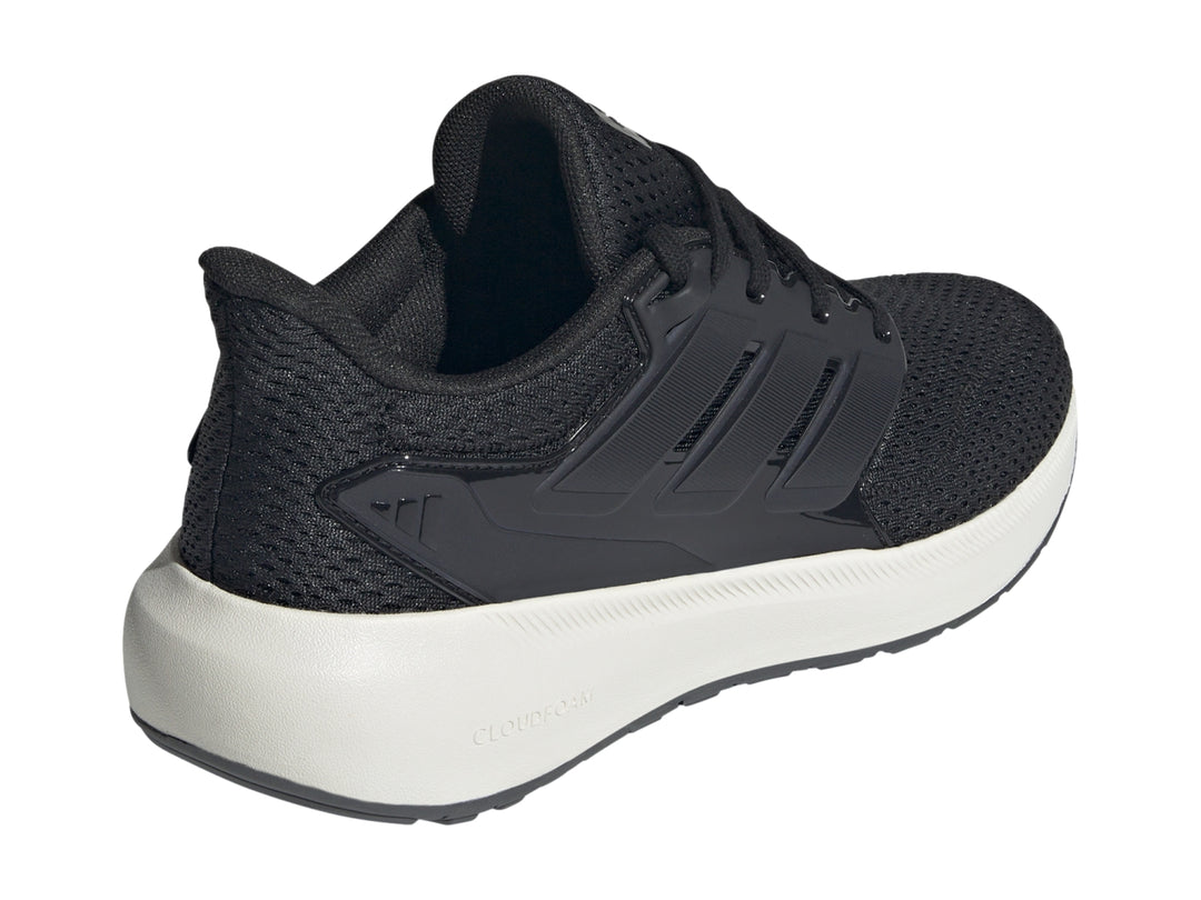 Tenis deportivos Adidas color negro con suela blanca y tejido de malla.