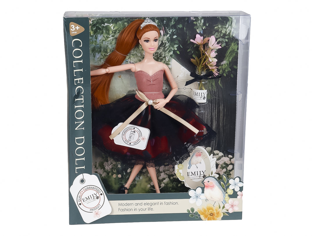 Muñeca de colección con vestido rosa y negro, tiara y cabello largo, presentada en su caja transparente.