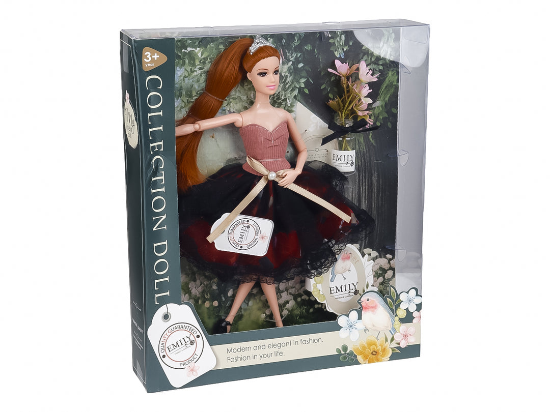 Muñeca de colección con vestido rosa y negro, tiara y cabello largo, presentada en su caja transparente.