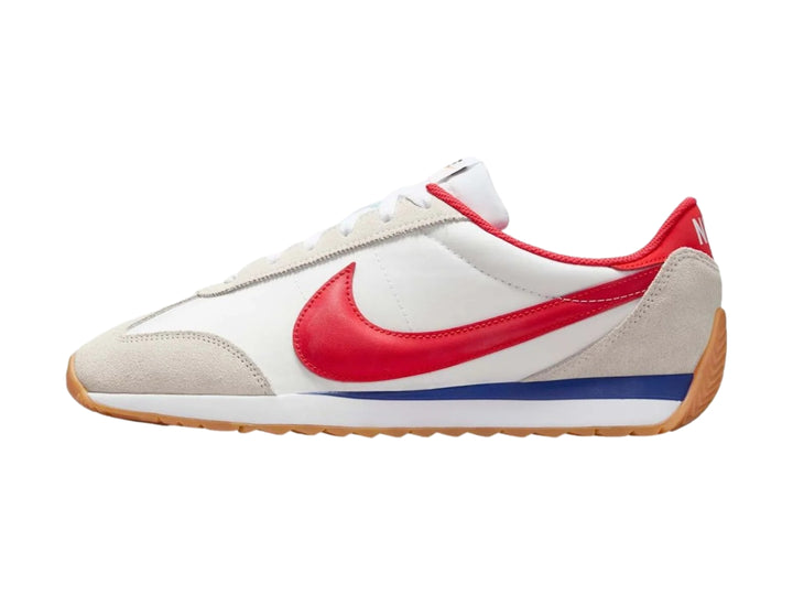 Tenis Nike blancos con detalles en gris, suela color miel y logotipo rojo en el costado.