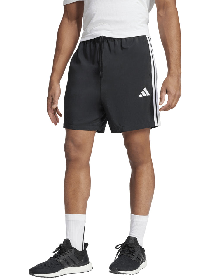 Pantalones cortos deportivos Adidas color negro con tres franjas blancas laterales y logo blanco.