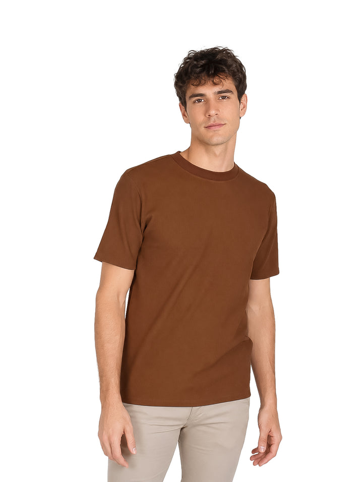 Hombre vistiendo una camiseta básica de color café con cuello redondo y manga corta.