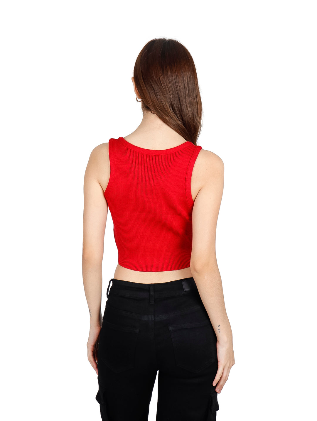 Mujer vistiendo un crop top rojo sin mangas con pequeños detalles brillantes y pantalones negros.