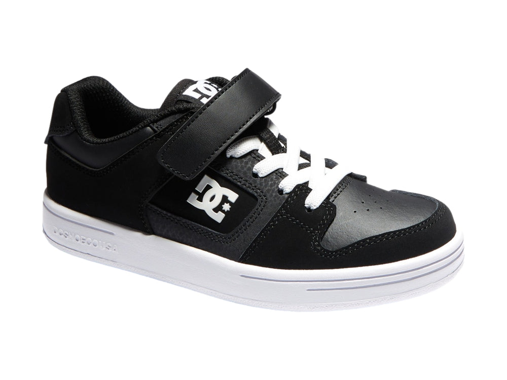 Tenis DC Shoes para niño en color negro y blanco con cierre de velcro y suela blanca.