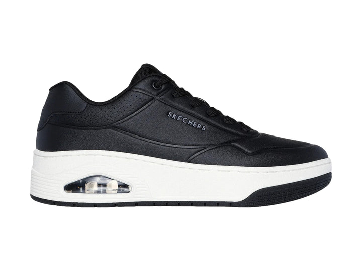 Tenis Skechers Uno Court color negro con suela blanca y cámara de aire visible en el talón.