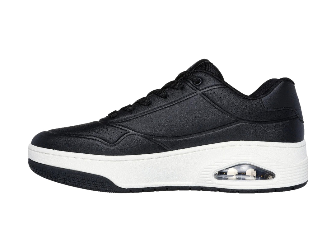 Tenis Skechers Uno Court color negro con suela blanca y cámara de aire visible en el talón.