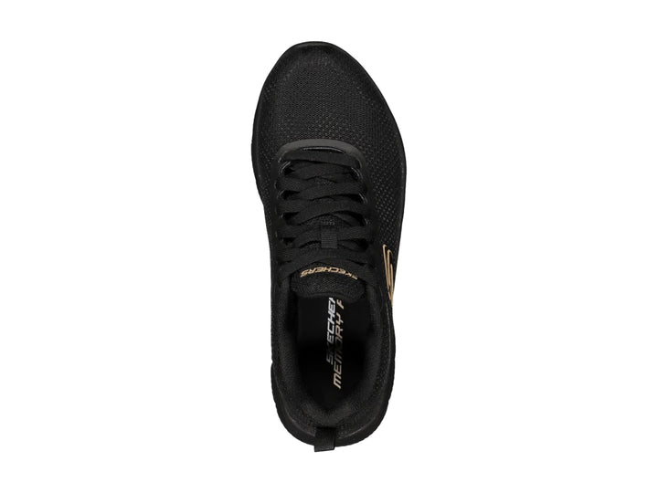 Tenis deportivos Skechers color negro con suela flexible y logotipo en dorado en el costado.