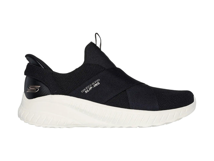 Tenis Skechers Slip-ins color negro con suela blanca, diseño deportivo y sin cordones.