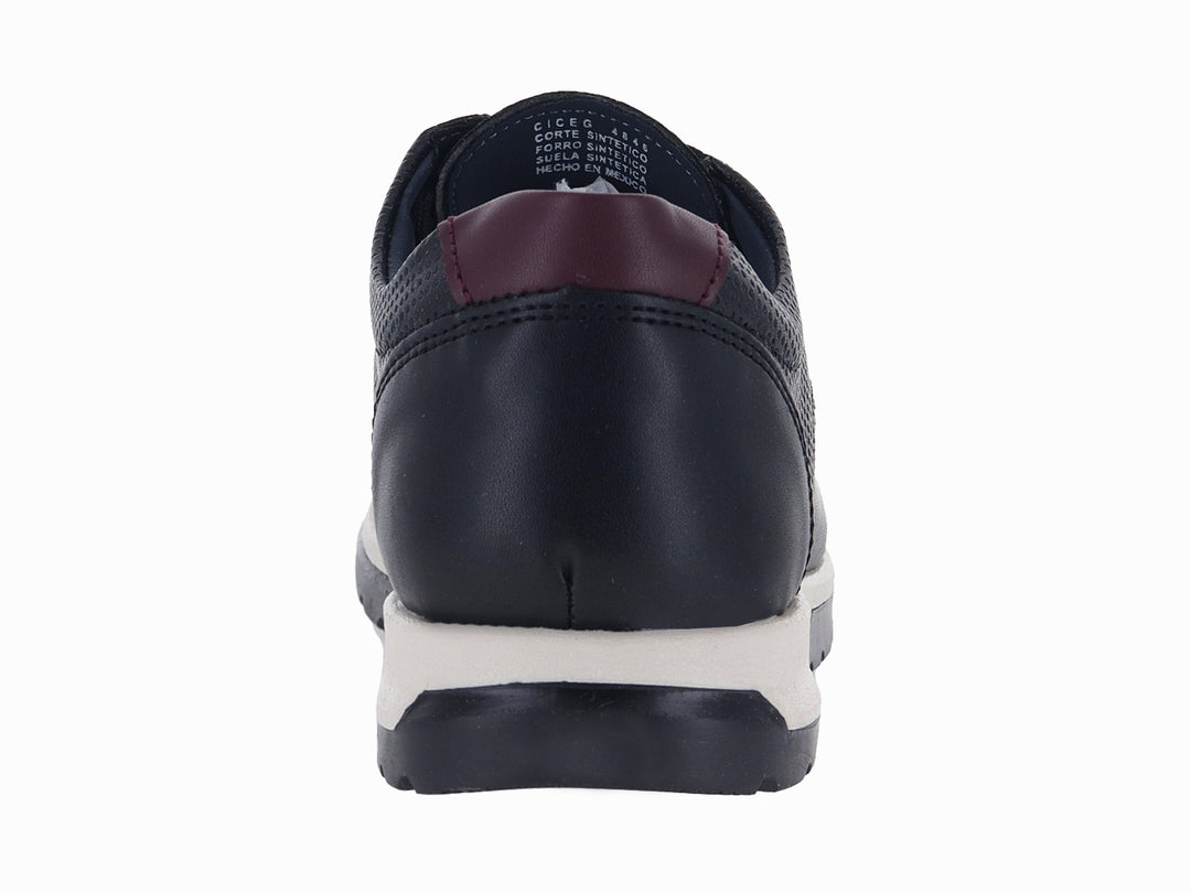 Zapato casual negro para niño con suela blanca y detalles en color guinda.