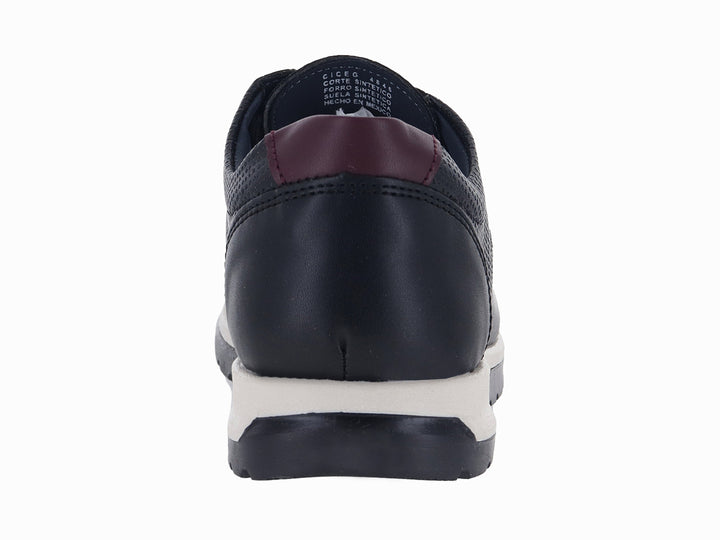Zapato casual negro para niño con suela blanca y detalles en color guinda.