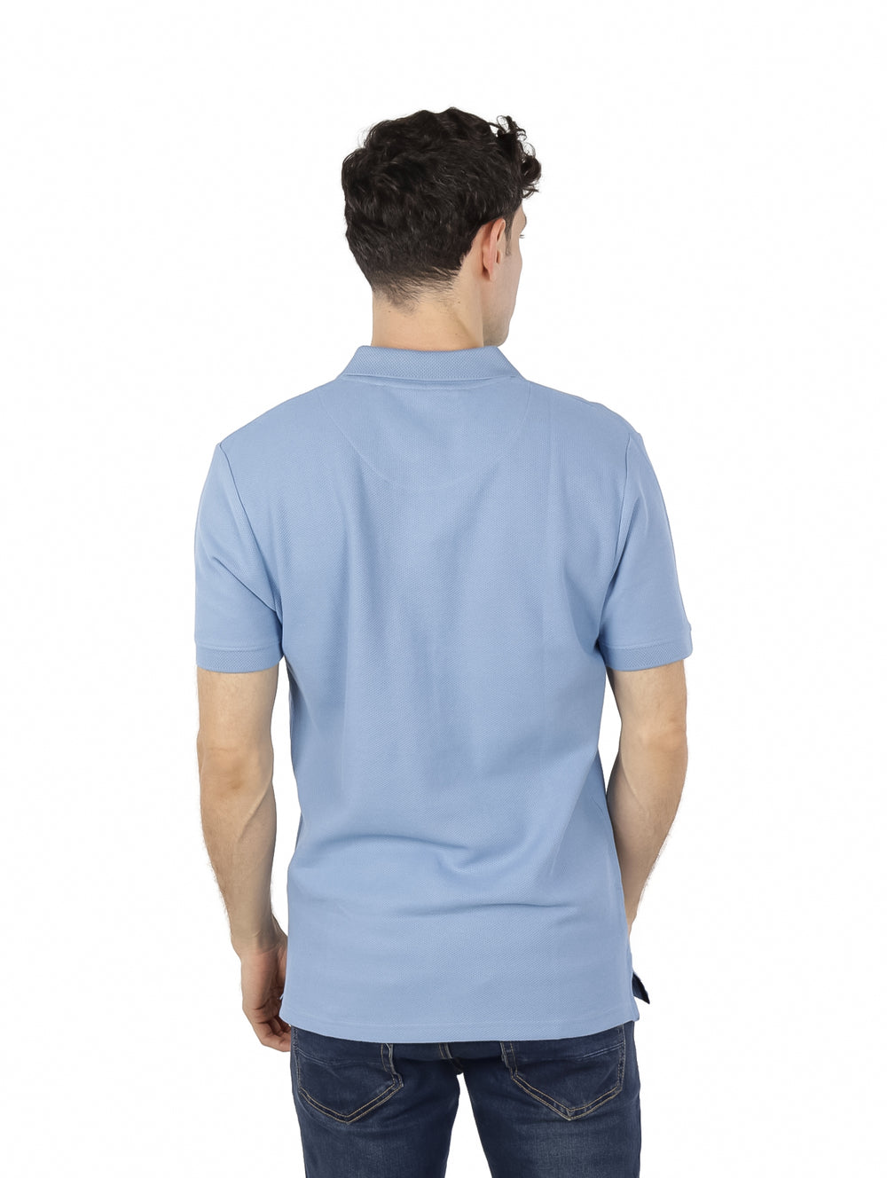Hombre vistiendo una playera polo de color azul claro con cierre frontal y manga corta.