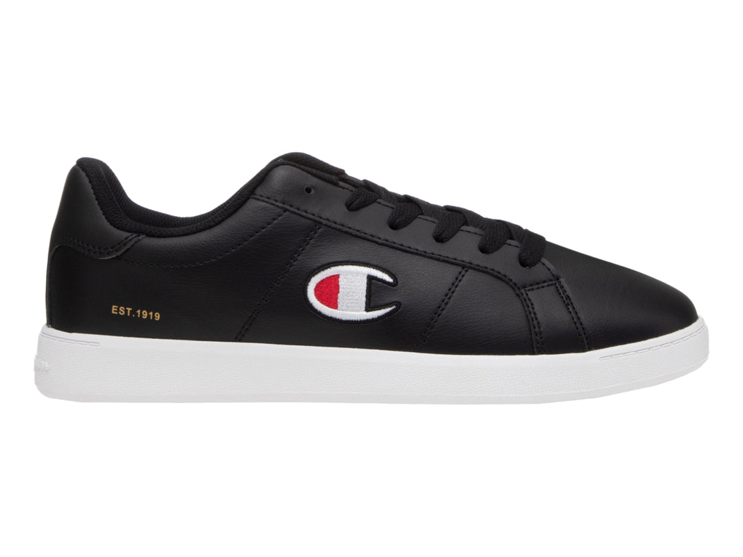 Tenis Champion color negro con suela blanca y logotipo lateral en blanco y rojo.
